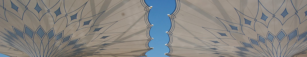Two white islamic style ceiling screens with blue diamond patterns on them