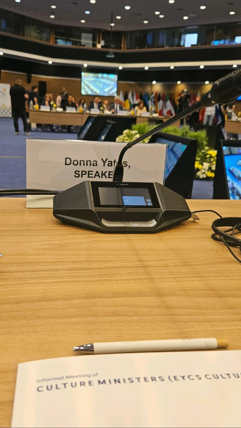 Conference speaking microphone in front of a label that says DONNA YATES SPEAKER
