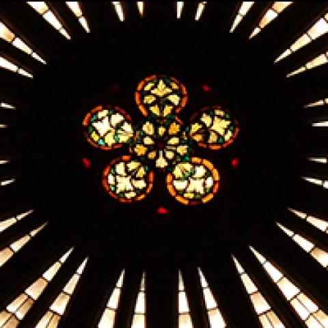 A circular stained glass window in a French church