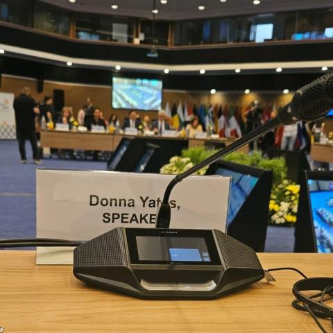 Conference speaking microphone in front of a label that says DONNA YATES SPEAKER
